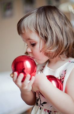 child decorating the tree